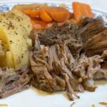 pot roast served with potatoes and carrots