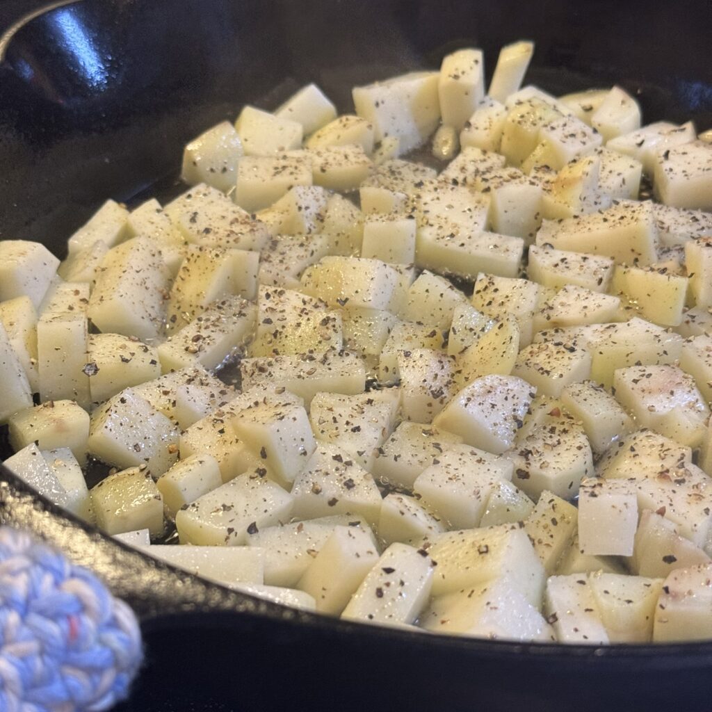 crispy beef tallow potatoes  in a cast iron skillet